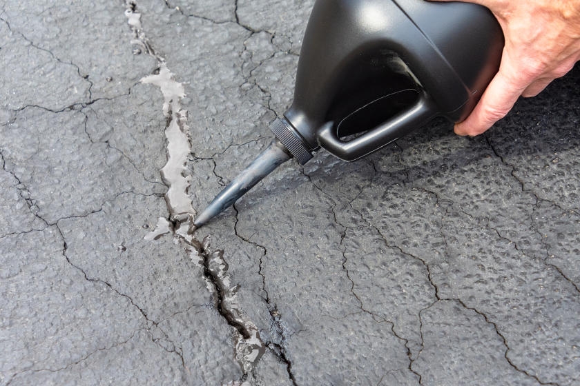 How to Repair Cracks in Your Asphalt or Concrete Driveway